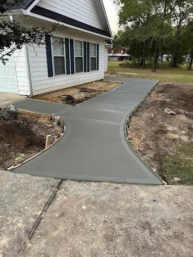 Finished curved concrete sidewalk in Houston TX by Leatherwood Lawn Specialists | commercial landscaping, lawn care, lawn maintenance, drainage, concrete, outdoor solutions near Houston TX Finished curved concrete sidewalk in Houston TX by Leatherwood Lawn Specialists