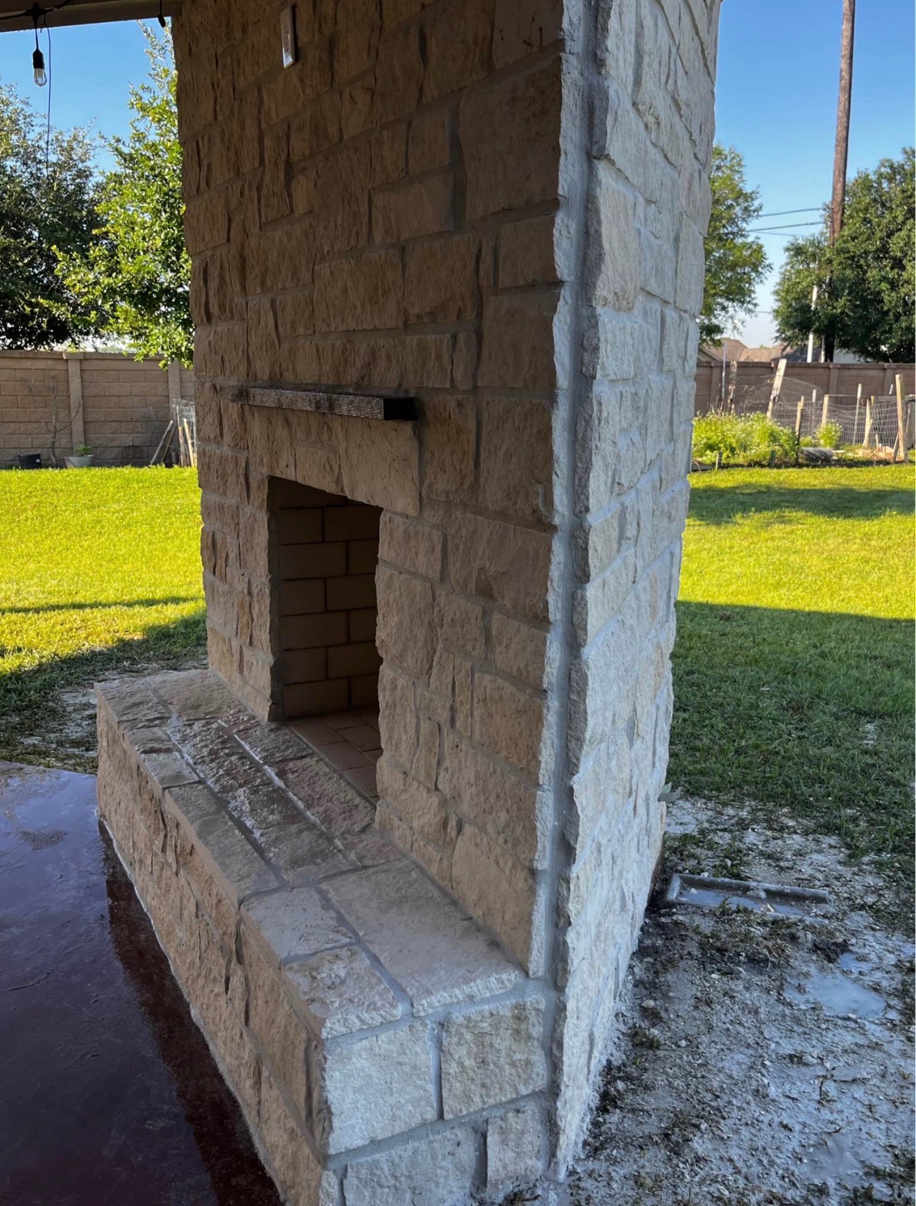 Outdoor stone fireplace masonry service in Houston TX by Leatherwood Lawn Specialists